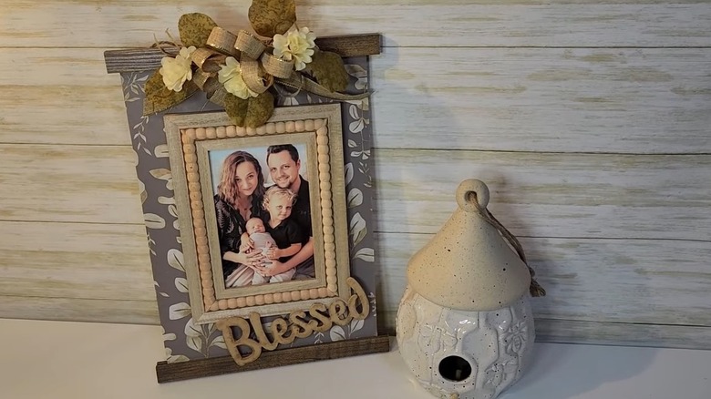 A decorated family picture on a wood board