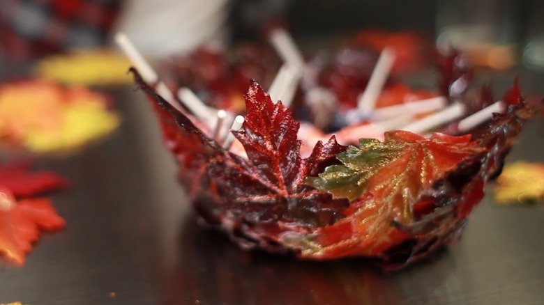 A maple leaf bowl holding candies