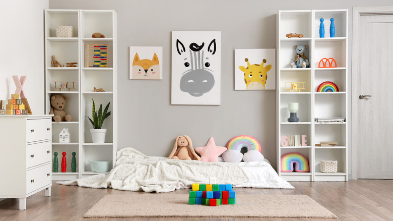 A neatly organized child's playroom decorated in shades of white