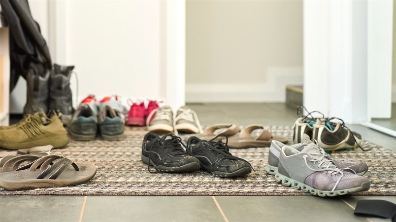 pairs of shoes scattered around a home's entryway
