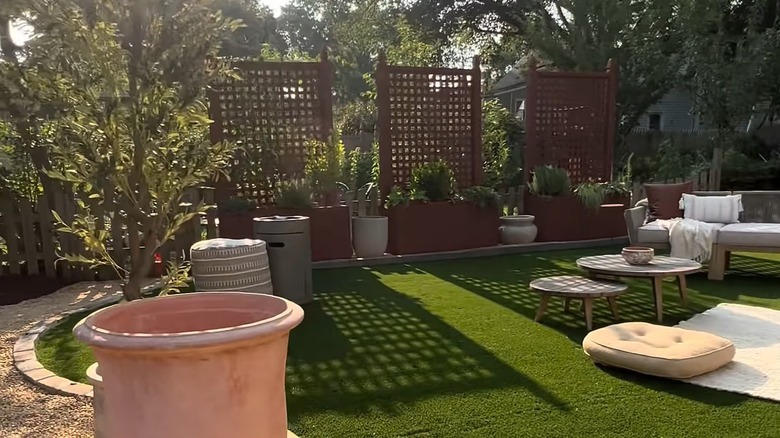 A landscaped backyard with lattice privacy planters.