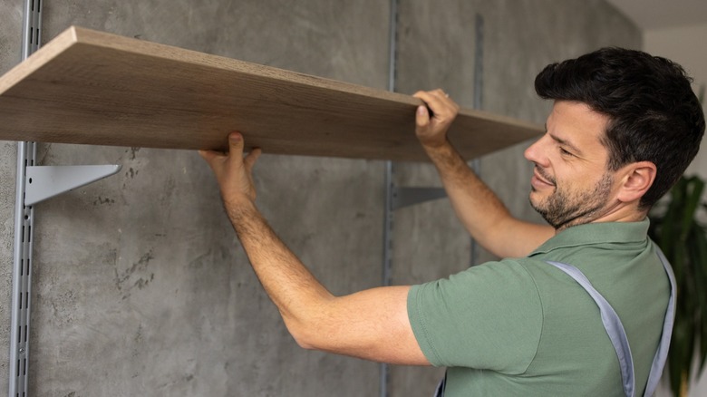 A handyman installing a shelf