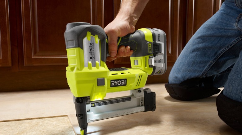 A close up shot of a Ryobi stapler in use