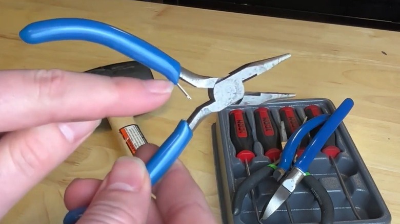 Person holding a broken Harbor Freight tool