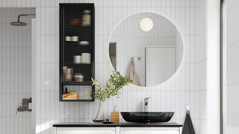 Bathroom with round back-lit mirror