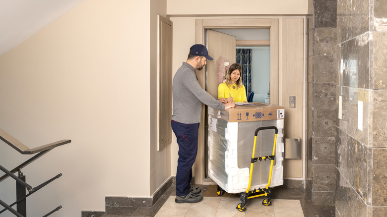 a delivery person delivering a home appliance