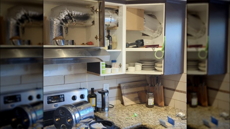 Photo of a DIY exhaust hood fan going through kitchen cabinets