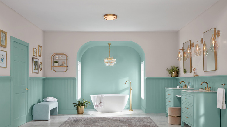 A bathroom with Renew Blue by Valspar on the bathroom cabinets and bottom walls