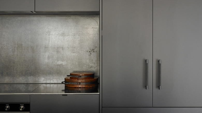 Gray kitchen cabinets with smokey bronze pulls