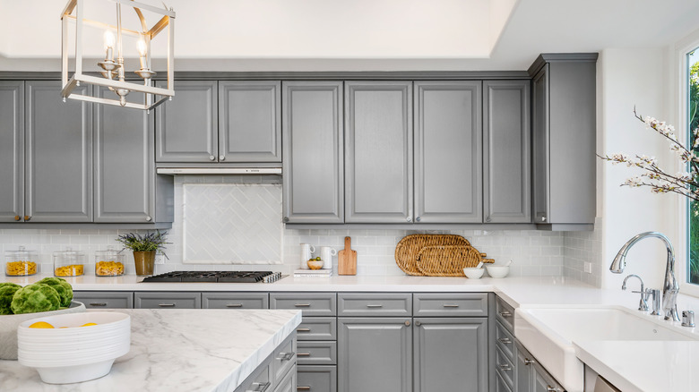 A modern kitchen with gray cabinetry