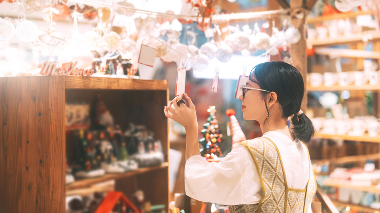 close up of a woman shopping for holiday decor