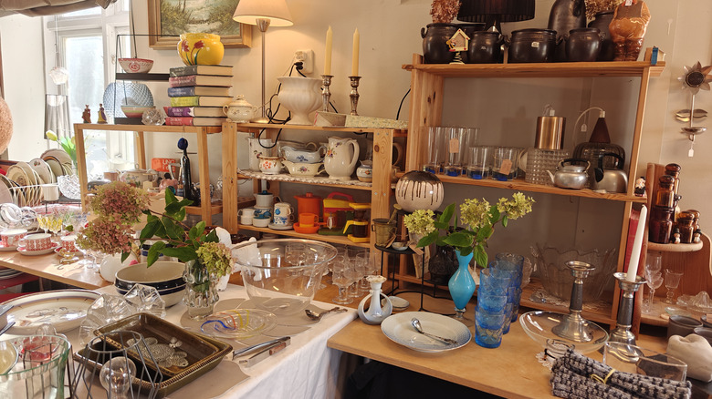 a thrift store shelf full of home decor and antiques