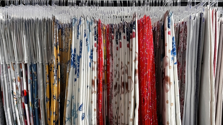 close up of tablecloths hanging in a store