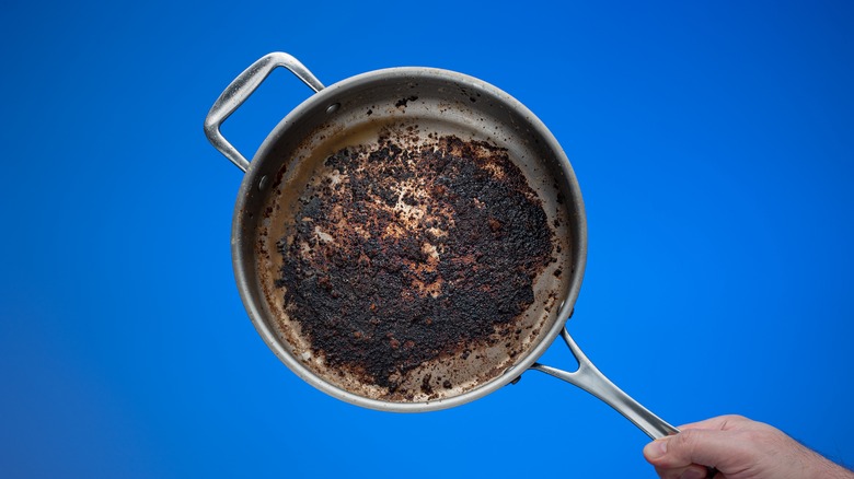burnt pan on blue background