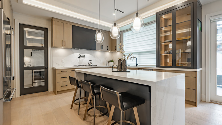 Modern two-toned kitchen with large white island and four chairs