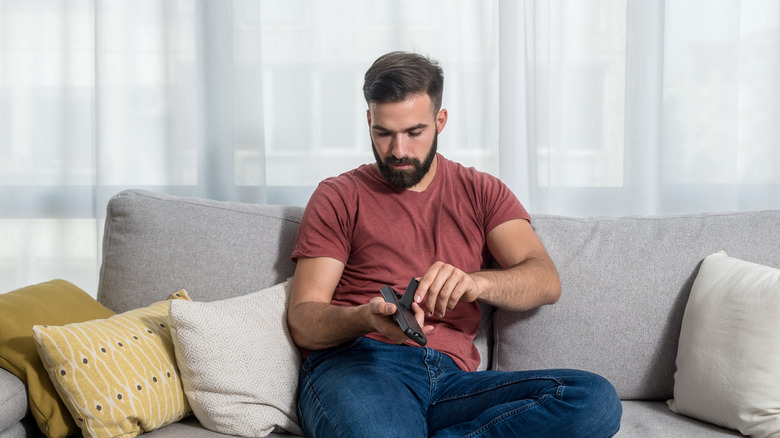 Man checking remote battery