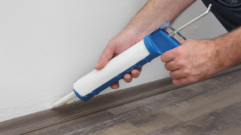 person caulking 