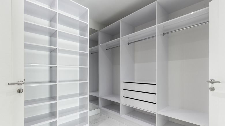 An large empty custom closet with shelves, rods, and drawers