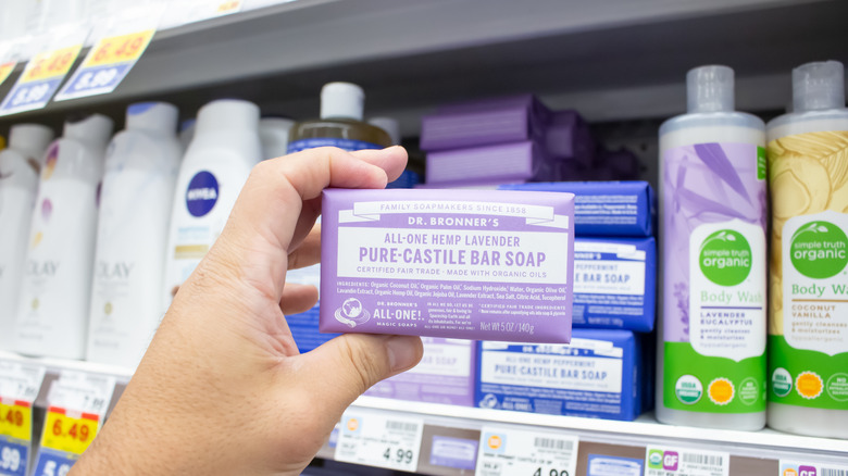 A bar of lavender castile soap held up in store aisle