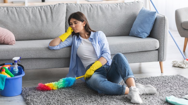 woman tired from dusting house