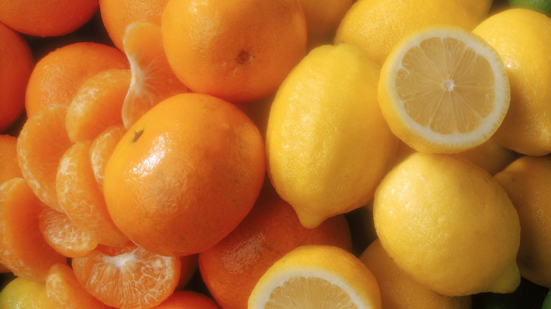 a close up of oranges and lemons 
