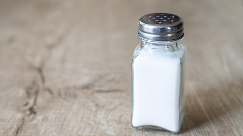 Salt shaker on wood table