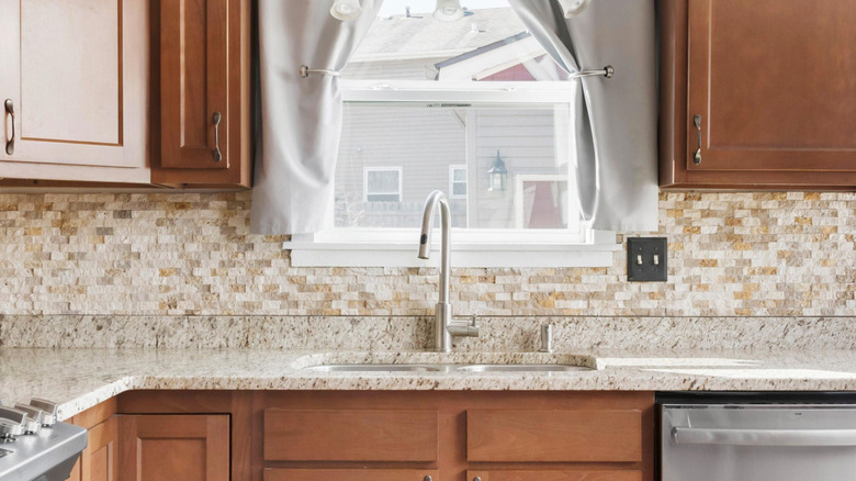 outdated tile backsplash in kitchen