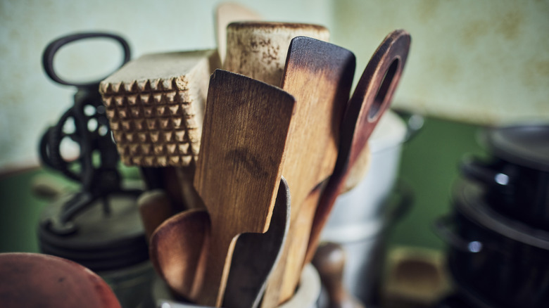 Old wooden kitchen utensils stored together