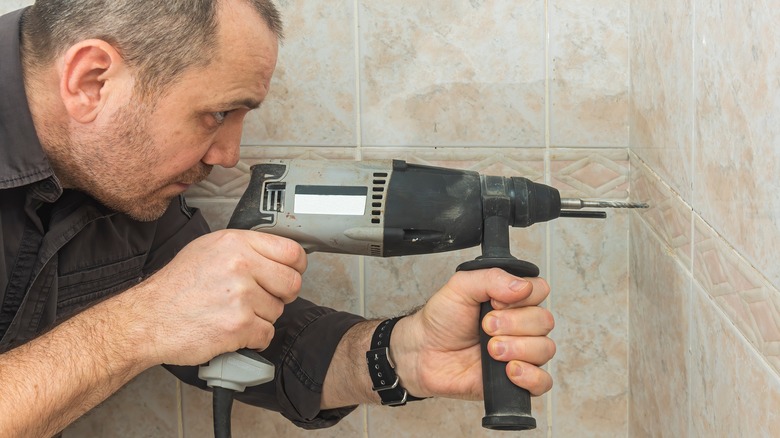 Man drilling into tile