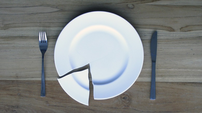broken plate with cutlery 