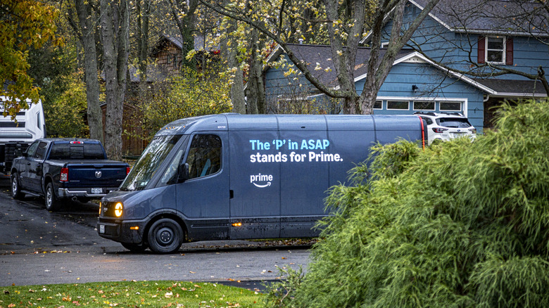 An Amazon delivery truck blocks a residential driveway