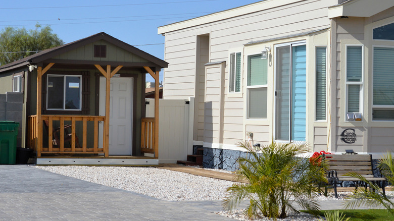 Converted shed tiny home next to a standard house
