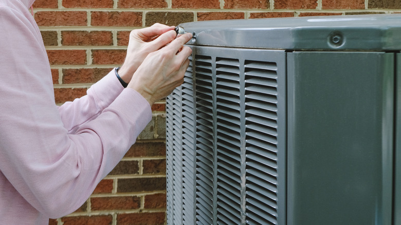 Person working on an outdoor A/C unit