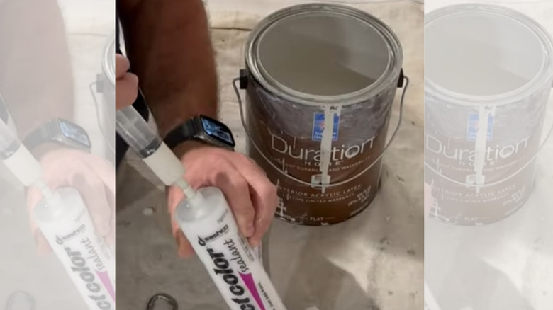 A person adding paint to caulk in a syringe