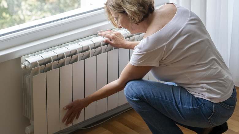 A person checking radiator installation