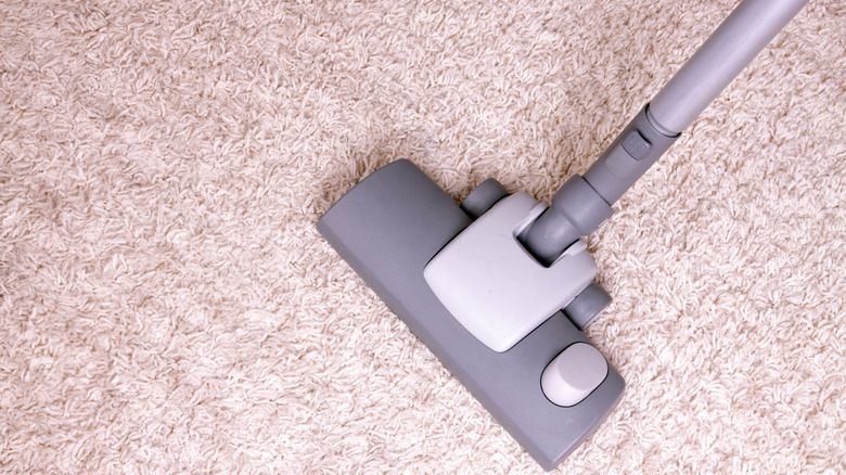 Vacuuming a natural pink rug