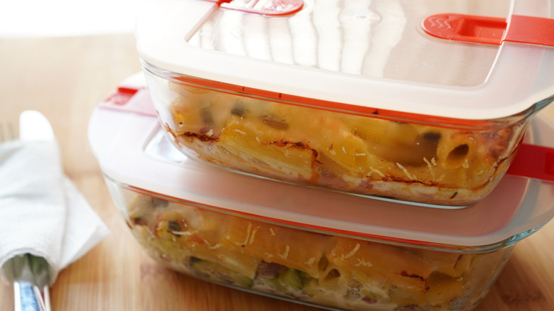 A close-up of food frozen in glass tupperware containers
