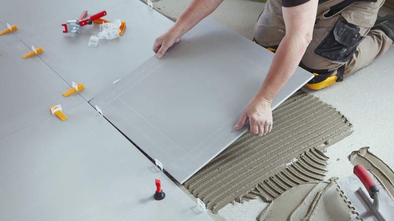 person installing tile floor