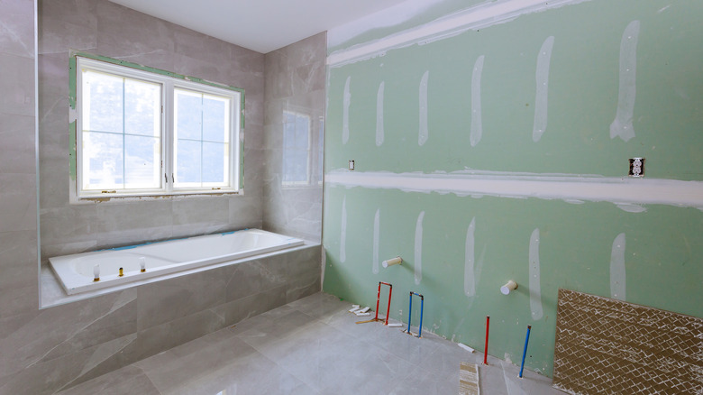 Bathroom with exposed drywall