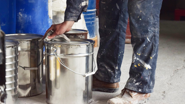 Painter wiping silver paint can