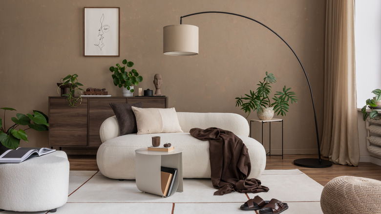 A modern living room with an arced floor lamp