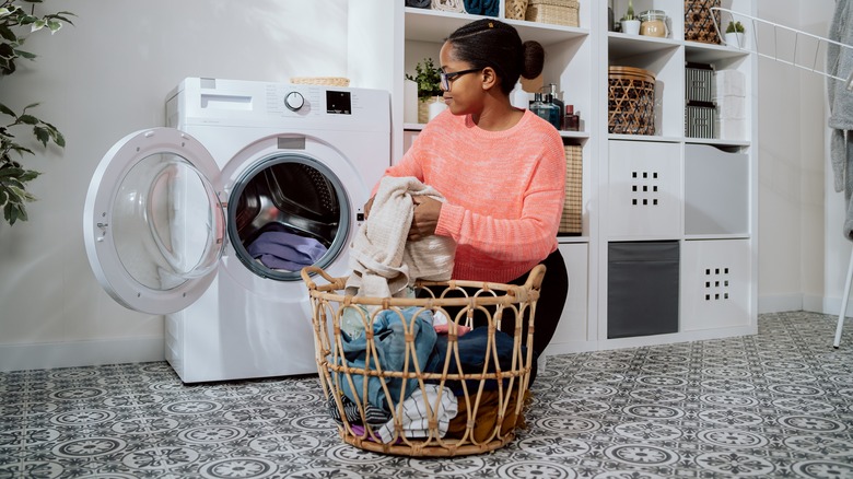 Someone filling washing machine