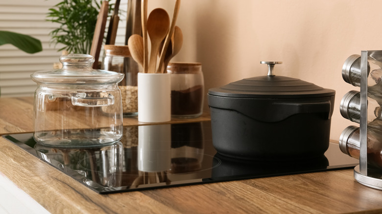 Glass and cast iron pot on induction stove top