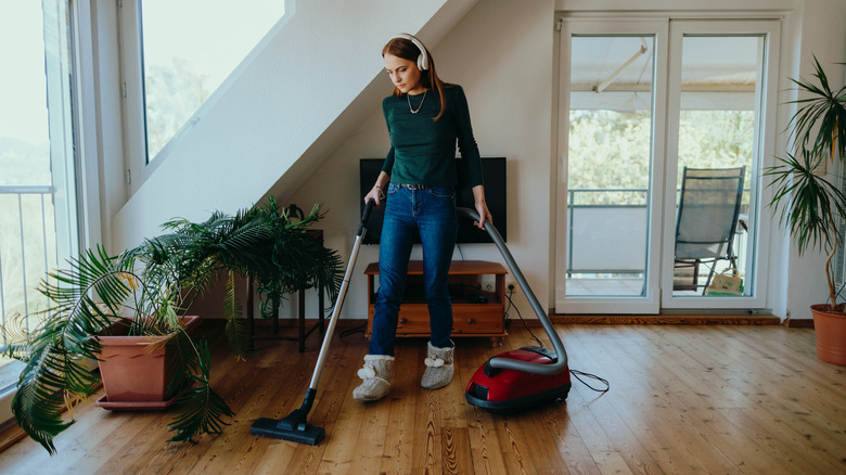 Woman hoovering wood floor