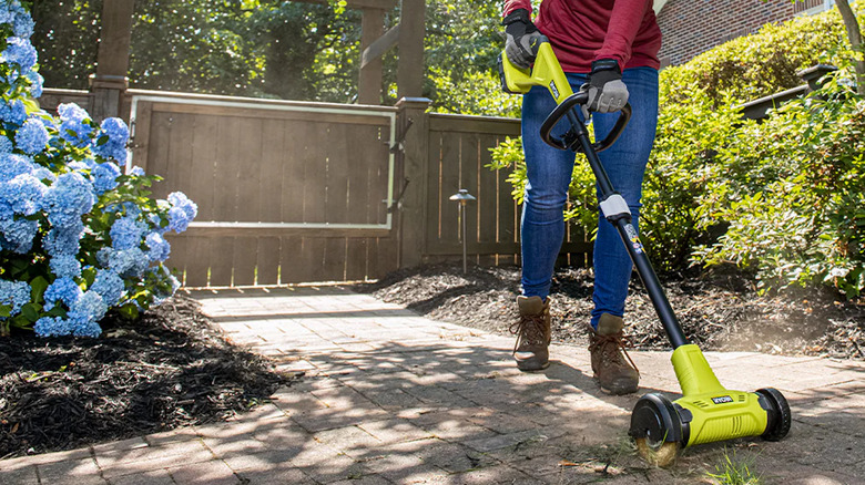 The Ryobi patio cleaner in action on pavers