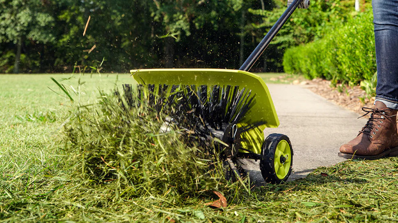 Ryobi's Expand-It sweep powered on a grass lawn