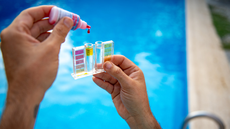 Person conducts pool water test