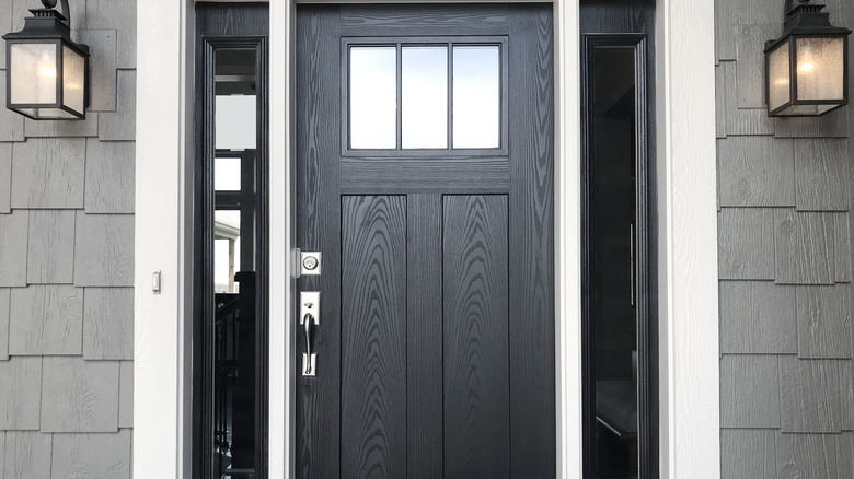 A black front door on a modern home.
