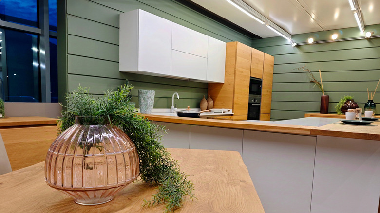Honey oak kitchen cabinets with sage green walls
