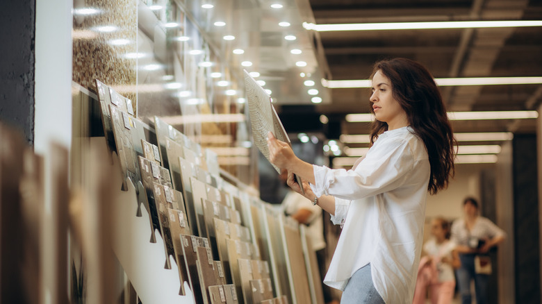 Woman looking at flooring samples in a store
